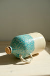 Green Pine olive oil bottle lying on its side
