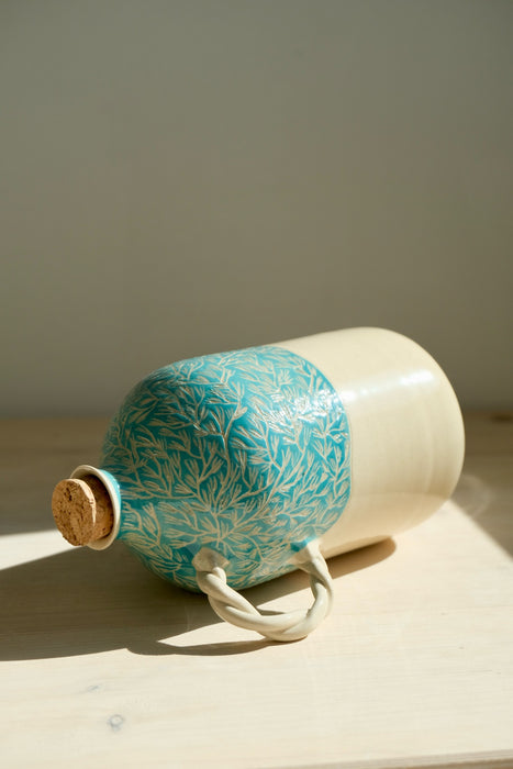 Green Pine olive oil bottle lying on its side