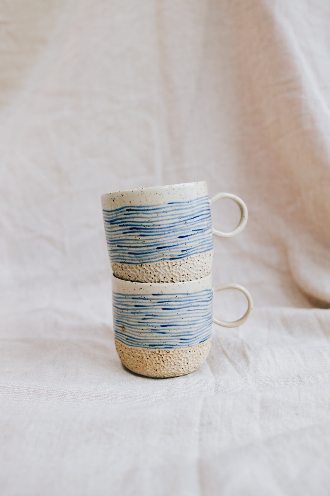 Latte Waves cups – handmade stoneware mugs with blue wave lines, stacked