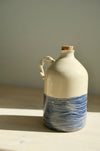 Deep Blue olive oil bottle – handmade ceramic olive oil bottle with carved blue wave lines, cork and twisted handle