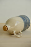 Deep Blue olive oil bottle lying on its side