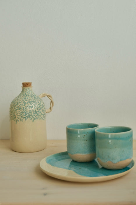 Pine olive oil bottle with Beach espresso cups on a Sea plate