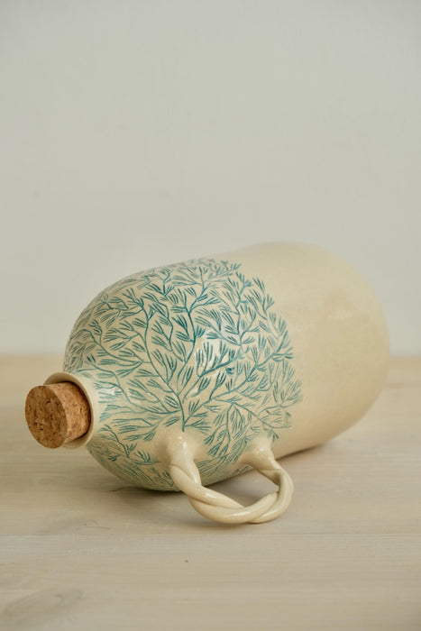 Pine olive oil bottle lying on its side