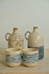 Deep Blue olive oil bottle with an olive bottle and two blue-striped cups